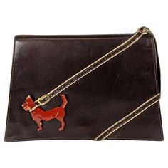 Rare Collectible High Art Deco Bakelite Dog Calf Leather Clutch from the 1930's by Virginia Bags. A carved and patinaed futurist bakelite dog is anchored by a perforated leather leash which becomes the handle at the top of the bag. 1930's. 9" x 6" x 1.5". Handle 4.5". Art Deco Bag, New York Fits, Gorgeous Clothes, Estilo Art Deco, High Art, Perforated Leather, Purse Accessories, Old Art, Vintage Handbags