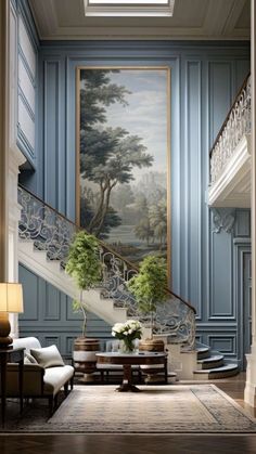 an elegant staircase with blue walls and paintings on the wall