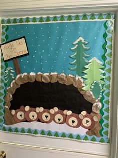 a bulletin board with bears and a sign on the front door that says welcome to us this winter