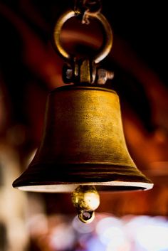 a bell hanging from the ceiling in a room