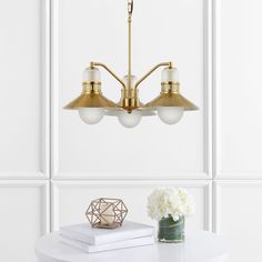 This coastal inspired, triple-globe chandelier has vintage style, dressed up in a brass-gold finish. The metal shades add a bright brass accent, while the frosted glass globes cover the LED bulbs for soft, bright light. This versatile chandelier with three lights is perfect over a kitchen or dining room table. JONATHAN Y Colin 22" / Adjustable Retro Hurricane 3-Light Oil-Rubbed Gold Transitional Crystal Chandelier | JYL6122A Glass Globes, Globe Chandelier, Brass Accents, Brass Gold, Bright Light, Glass Globe, Room Table, Crystal Chandelier, Dining Room Table