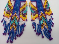 "Beautifully handmade Native American Style Seed Bead Earrings with woven in a combination of desert and mountain colors. Traditional native style design at nearly 6\" off the ear. Colors and styling great for matching your favorite dancing regalia or to wear on its own. Made with stainless steel ear wires and genuine high quality beads. All handmade and Shipped Free from Hawaii with Aloha!" Powwow Regalia, Beaded Earrings Native, Desert Colors, Native American Style, Native Design, Handmade Earrings Beaded, Native Style, Design Seeds, Native American Fashion