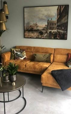 a living room filled with furniture and a painting on the wall