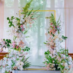 flowers and greenery are arranged on the altar