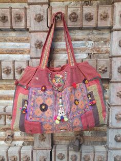 a red purse hanging on a wooden door