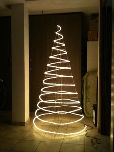 a lighted christmas tree in the middle of a room