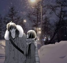 two people standing in the snow under a street light at night, with one person wearing a scarf