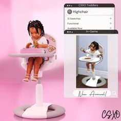 a small doll sitting in a highchair next to a computer screen with an image of a baby on it