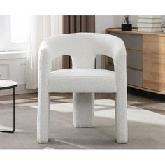 a white chair sitting on top of a carpet covered floor