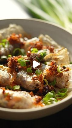 a white bowl filled with food on top of a table