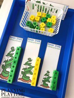 a blue tray with legos and green blocks on it