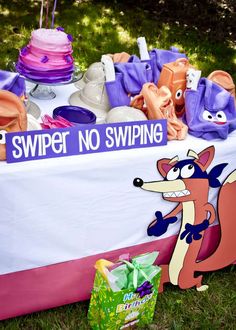 a table that has some items on it and is decorated like a fox with the words swiper no swinging