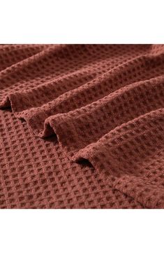 the textured fabric is brown and it looks like knitted fabric with small squares