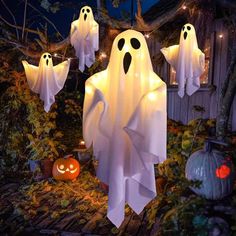 halloween decorations with ghost lights and pumpkins