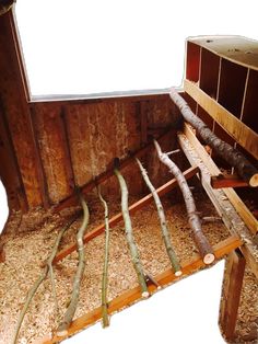 the inside of a wooden structure with logs and wood shavings on top of it