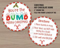 two round christmas tags with the words you're the bomb on them