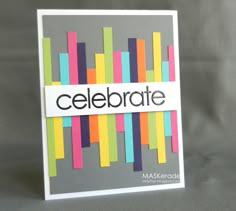 a close up of a card with the word celebrate written on it and colored strips