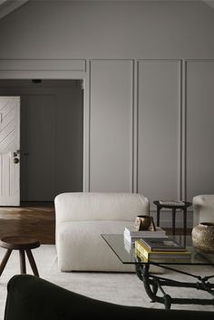 a living room with two couches and a coffee table in front of the door