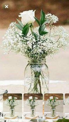 a vase filled with white flowers and baby's breath sitting on top of a table