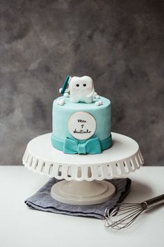 a blue cake with an owl on top