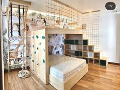 a bedroom with a bunk bed and climbing bars on the wall, next to a book shelf