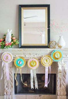 some ribbons are hanging on the mantle in front of a fire place with a mirror