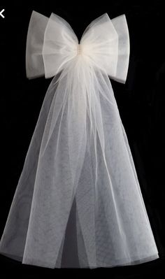 a white dress with a large bow on it