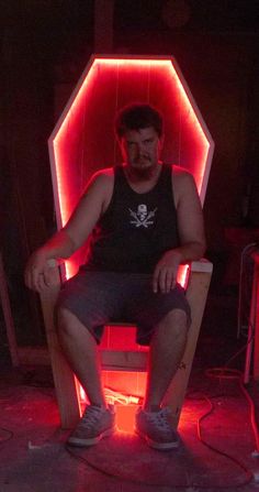 a man sitting in a chair with red lights