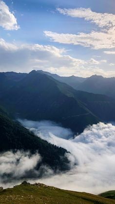 the mountains are covered in low lying clouds