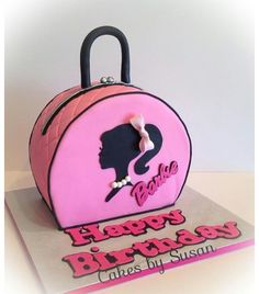 a cake shaped like a pink purse with the words happy birthday on it