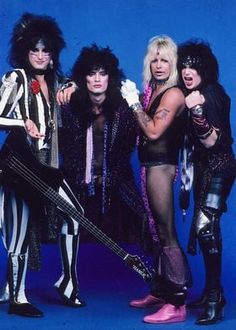 the band kiss posing for a photo with their guitars