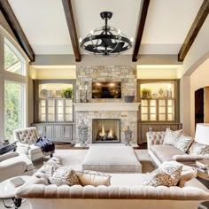 a living room filled with furniture and a fire place in the middle of a room