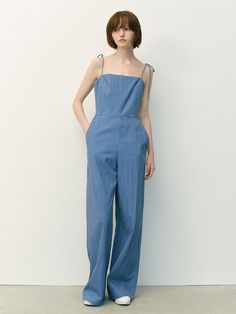 This product is a Bondai garment-washing sleeveless jumpsuit that captures the essence of relaxed summer style. It's crafted from a soft, washed fabric for an already-loved feel, and the wide-leg silhouette enhances its laid-back charm. The jumpsuit's sleeveless design and lightweight material make it ideal for warm-weather adventures. - The jumpsuit features delicate, adjustable spaghetti straps ensuring a comfortable fit for a variety of body types.- A square neckline adds a modern touch and provides a flattering frame for the collarbone.- The garment-washed fabric gives the jumpsuit a soft, comfortable feel with a casual, worn-in look.- Practical side pockets and a cinched waist with a tie enhance both the functionality and the style of this one-piece wonder. Casual Cotton Strapless Jumpsuit With Pockets, Cotton Sleeveless Jumpsuits And Rompers For Loungewear, Sleeveless Cotton Jumpsuits And Rompers For Loungewear, Summer Cotton Jumpsuits And Rompers With Tie Straps, Chic Cotton Jumpsuits And Rompers For Summer, Chic Cotton Summer Jumpsuits And Rompers, Casual Strapless Jumpsuit With Pockets For Summer, Summer Cotton Jumpsuit With Relaxed Fit, Casual Denim Jumpsuit With Adjustable Straps For Summer