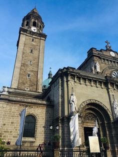 an old church with statues and a clock tower