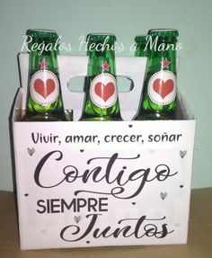 four bottles of beer in a box with the words cortige sempre juniors