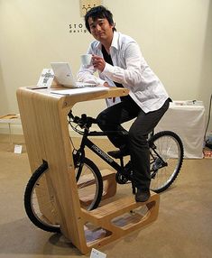 a man sitting at a desk on a bike with the words what does it mean?