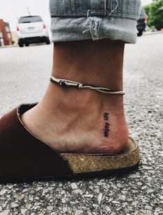 a woman's foot with a small tattoo on the ankle that reads, i love you