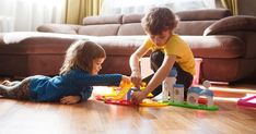 two children playing with toys on the floor