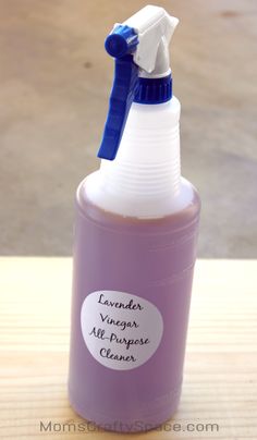 a purple bottle with a blue cap and a white plastic sprayer on it that says lavender vinegar all purpose cleaner