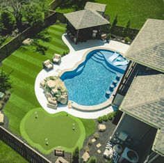 an aerial view of a backyard with a swimming pool