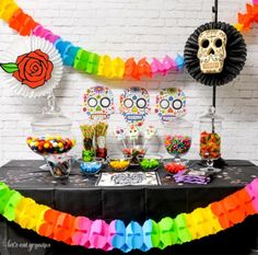 a table topped with candy and sugar skulls