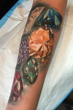 an arm with many different colored diamonds on it