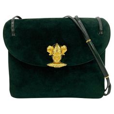 Judith Leiber Green Suede Gold Clown Shoulder Bag in very good condition. Green suede exterior trimmed with gold hardware and green bx calf leather. Front clown closure latch closure opens a single top flap to a triple compartment interior lined in green satin. Front compartment holds side zip pocket while back compartment holds side slit pocket. Overall very good condition. Gentle scuffs on exterior suede and shoulder strap- see photos for details. purchase includes matching suede coin purse an Judith Leiber Bags, Chanel Flap Bag, Patent Leather Handbags, Judith Leiber, Green Suede, Green Satin, Coin Pouch, Black Patent Leather, Flap Bag