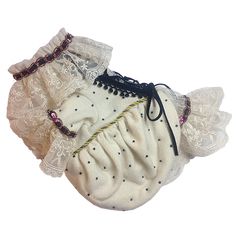 a pair of white gloves with lace and beaded trims on the sides, tied together