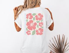 Step into summer with this charming Hibiscus Flower Beach T-Shirt! Designed to evoke tropical vibes and laid-back beach days, this tee features a vibrant hibiscus flower print that will instantly uplift your wardrobe. Made from soft and breathable fabric, this t-shirt is perfect for both lounging by the beach or casual outings with friends. Add a touch of island paradise to your style with this must-have summer essential! 🖤 Comfort Colors introduces the "Comfort Colors 1717" garment-dyed t-shir White Hibiscus Print T-shirt For Spring, White Tropical T-shirt For Beach Season, Beachy Short Sleeve Hawaiian Shirt For Spring, Tropical Camp Shirt For Spring Beach Occasions, Spring Tropical Camp Shirt For Beach, Spring Vacation Hibiscus Print Camp Shirt, Spring Tropical Beach Camp Shirt, Tropical Spring Beach Camp Shirt, White Vacation Tops With Palm Tree Print