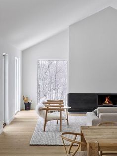 a living room filled with furniture and a fire place in the middle of a room