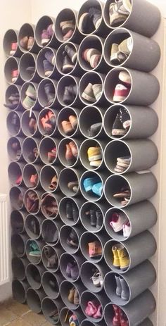 an organized shoe rack in the corner of a room