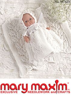 a baby doll laying on top of a white crocheted blanket