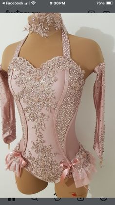 a pink leotard dress with sequins and bows