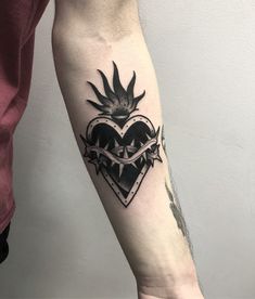 a man with a heart tattoo on his arm